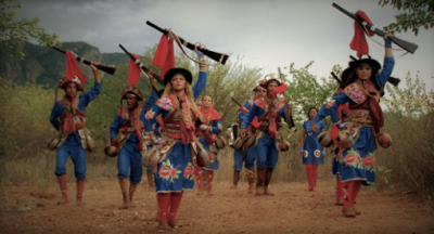 Troupe de danseurs de xaxado costumés dans le sertao au Brésil brandissant des faux fusils.